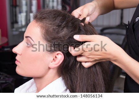 young beautiful brunette woman in hairdressing salon