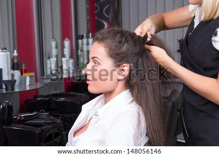 young attractive brunette woman in hairdressing salon
