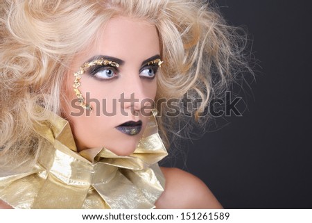 young mysterious woman with blondie shaggy hair and creative makeup