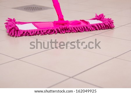 House tile floor cleaning with pink mop