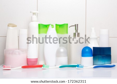 set of hygiene supplies over tiled wall in bathroom