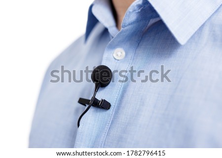 sound recording and broadcasting concept - close up of small lavalier clip-on microphone on male shirt ストックフォト © 