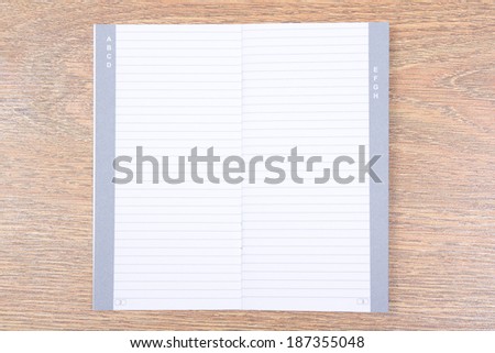 empty contact notebook on wooden desktop