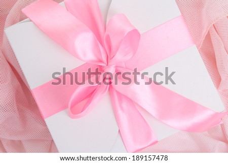 close up of gift box with pink ribbon and bow