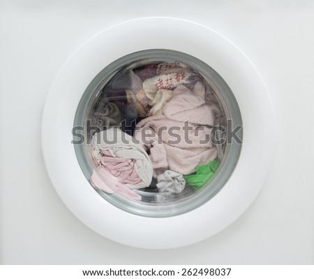 close up of dirty laundry inside of washing machine