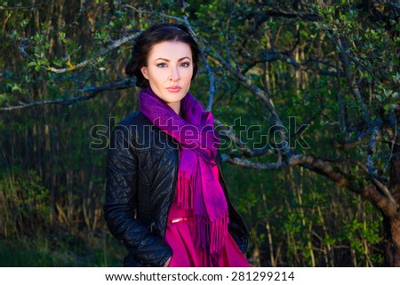 portrait of young beautiful woman in spring forest