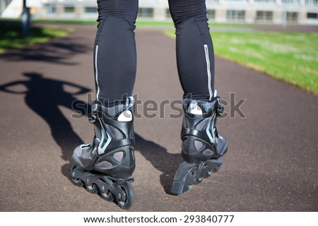close up view of slim female legs in roller blades