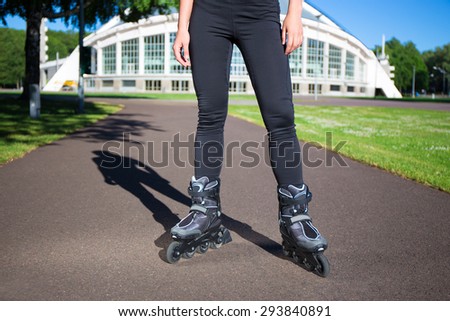 Inline skates - close up of slim female legs in skates