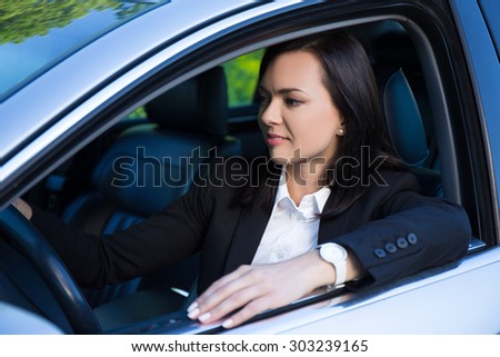 young beautiful successful business woman driving her car