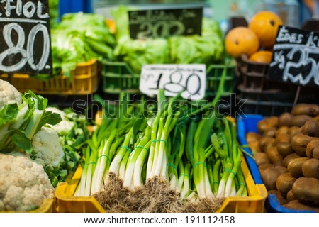 Fresh colorful spring vegetable bunches on marketplace