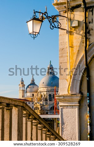 Old venetian house on the bank of The Grand Canal with The Santa Maria della Salute church on the background, Venice, Italy