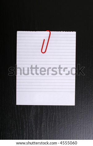 white lined paper on black wood background