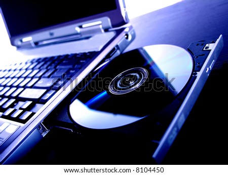 laptop with a disk dvd. blue tone