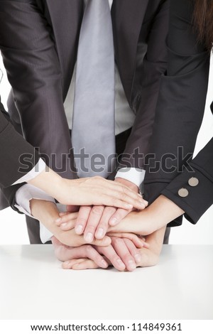 business team with hand together on the table for teamwork concept