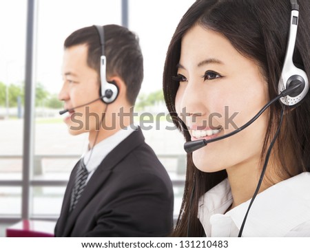 smiling asian businessman with call center agent