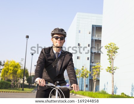 businessman riding a bicycle to workplace for protecting environment