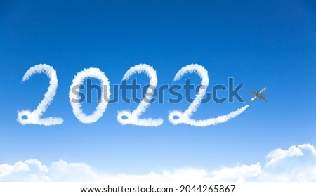 happy New year 2022 concept. cloud drawing by airplane in sky