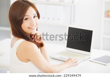 Young smiling asian woman  with laptop