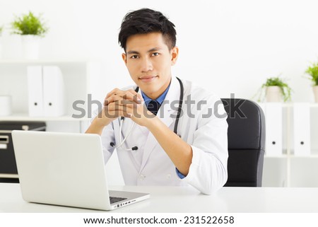 young doctor working with laptop in office