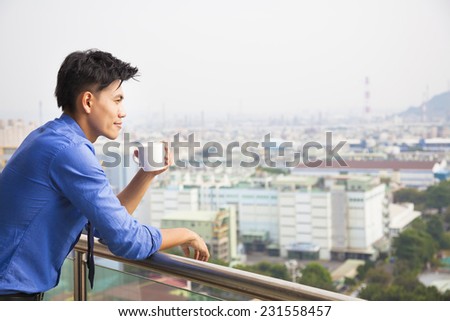 relaxed businessman watching the city view
