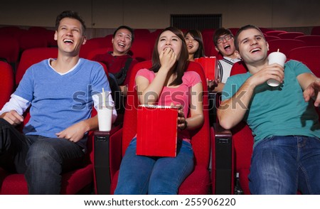 happy Young people  watching a movie at the cinema
