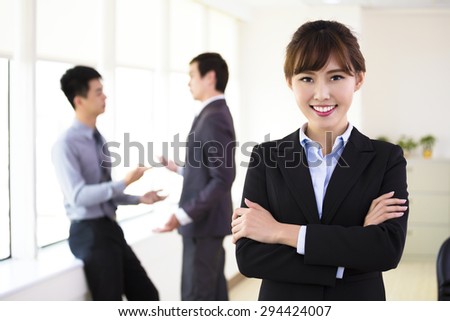 smiling young business woman standing in office