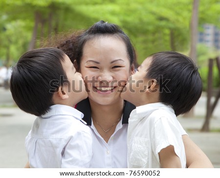 Happy mothers day. two kids kissing mother