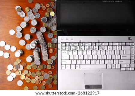 Laptop computer and coins\
Photo of a laptop computer and coins