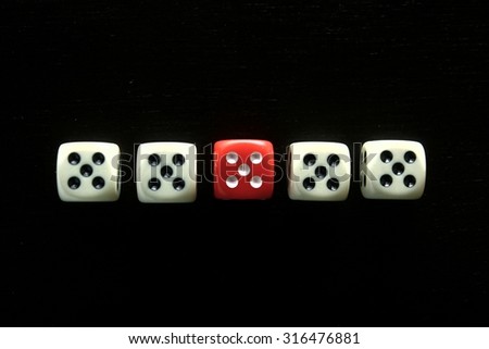 One Red game dice and four white game dice