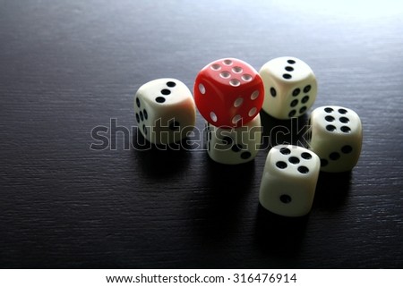 One Red game dice and five white game dice