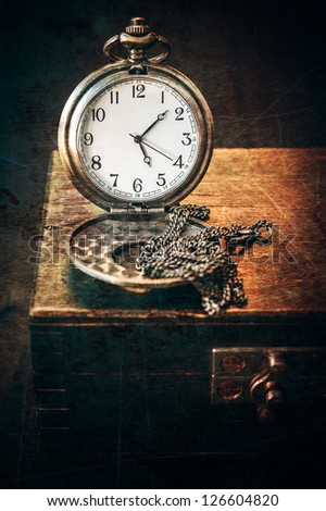 Vintage watch on a chain and the old chest
