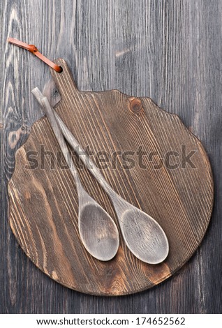 Old wooden cutting board and serving spoons