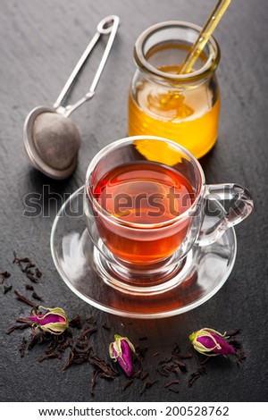 Herbal tea with rose flowers and honey. Concept of health.