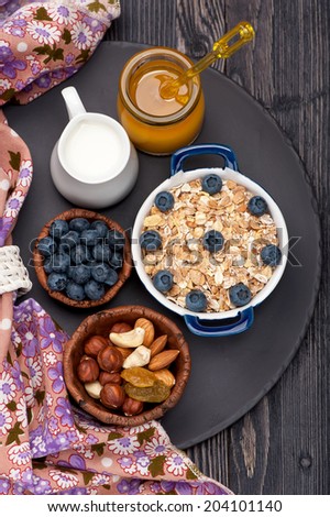 Muesli with raisins, nuts, honey and blueberries. Fitness breakfast