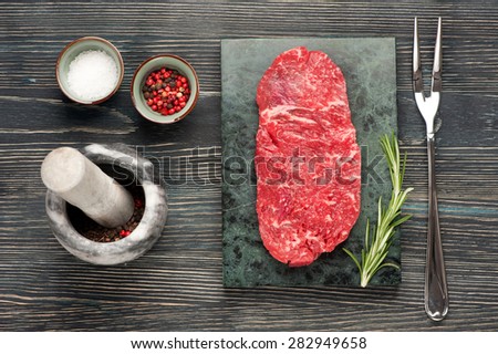 Raw steak Ribeye entrecote on dark wooden background