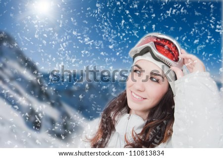 Portrait of young smiling woman against a background of the mountains