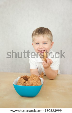 Cute little boy eating cookies