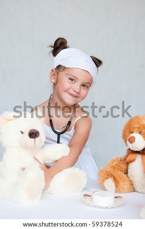 little girl doctor with teddy bear