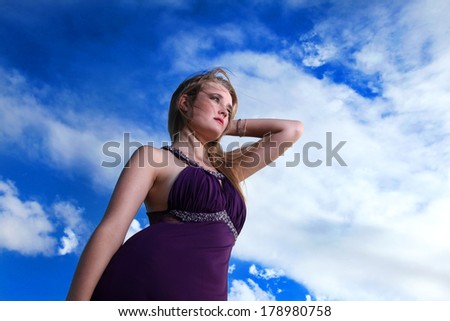 A beautiful blonde South African lady is photographed on location in her purple evening dress/ gown at sunrise.