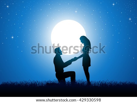 Silhouette of a man kneeling down and holding the hand of a standing woman against beautiful starry night and full moon.