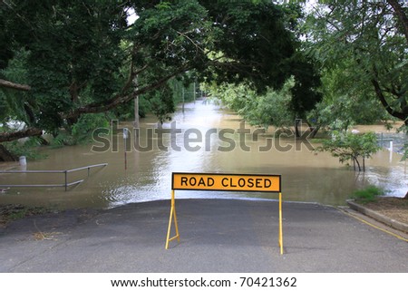 BRISBANE, QUEENSLAND/AUSTRALIA - JANUARY 13: Road closed sign in front of a flooded street on January 13, 2011 in Toowong, Brisbane, Queensland, Australia.