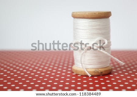 Real Old Spool of thread on polka dots background