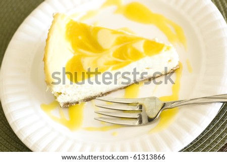Swirled Mango Cheesecake Served on a White Plate with a Fork