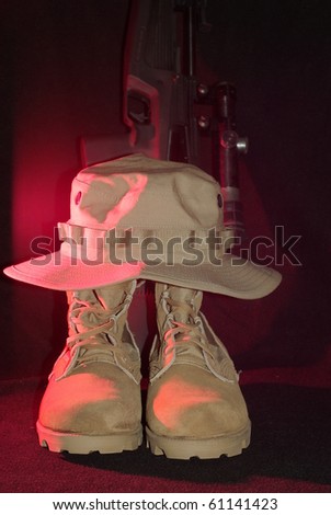 desert army boots with a hat and a gun