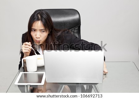 woman worker eating unhealthy food during the office hour.