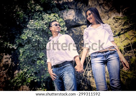 Couple kissing happiness fun. Interracial young couple embracing laughing on date. Asian couple on Thailand with the romance times