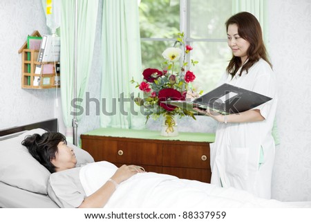 Portrait of a doctor with his co-workers talking with a patient