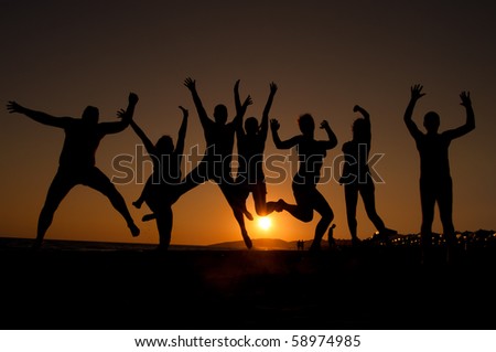 Group Of Happy Young People Silhouettes Jumping On The Beach On ...