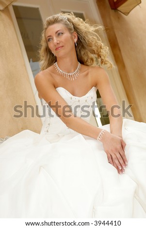 A bride sitting outside and wind blowing her hair