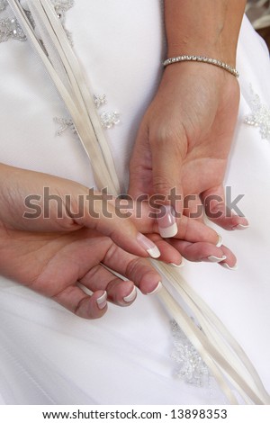 A bride holding her hands behind back